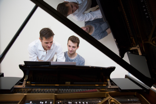 Tim Young at the piano with Jacob Abela
